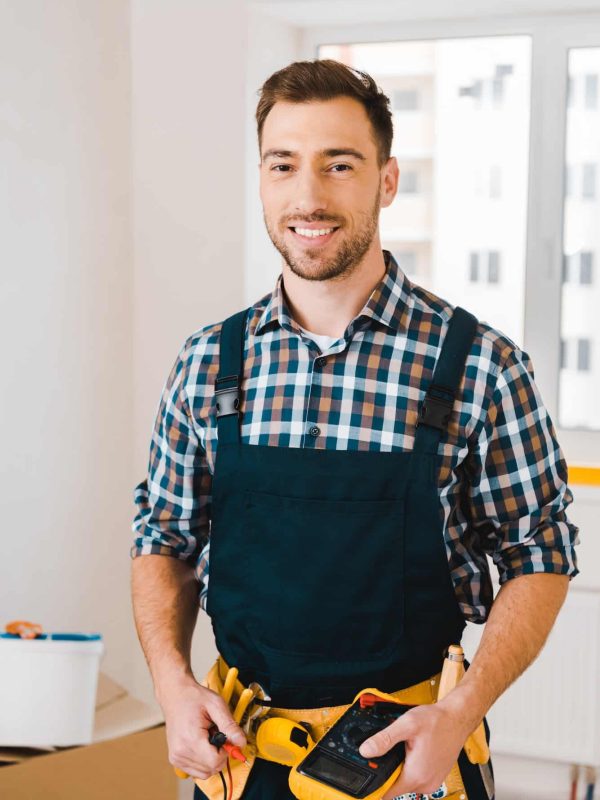 handsome-handyman-smiling-while-holding-digital-multimeter.jpg handsome-handyman-smiling-while-holding-digital-multimeter.jpg